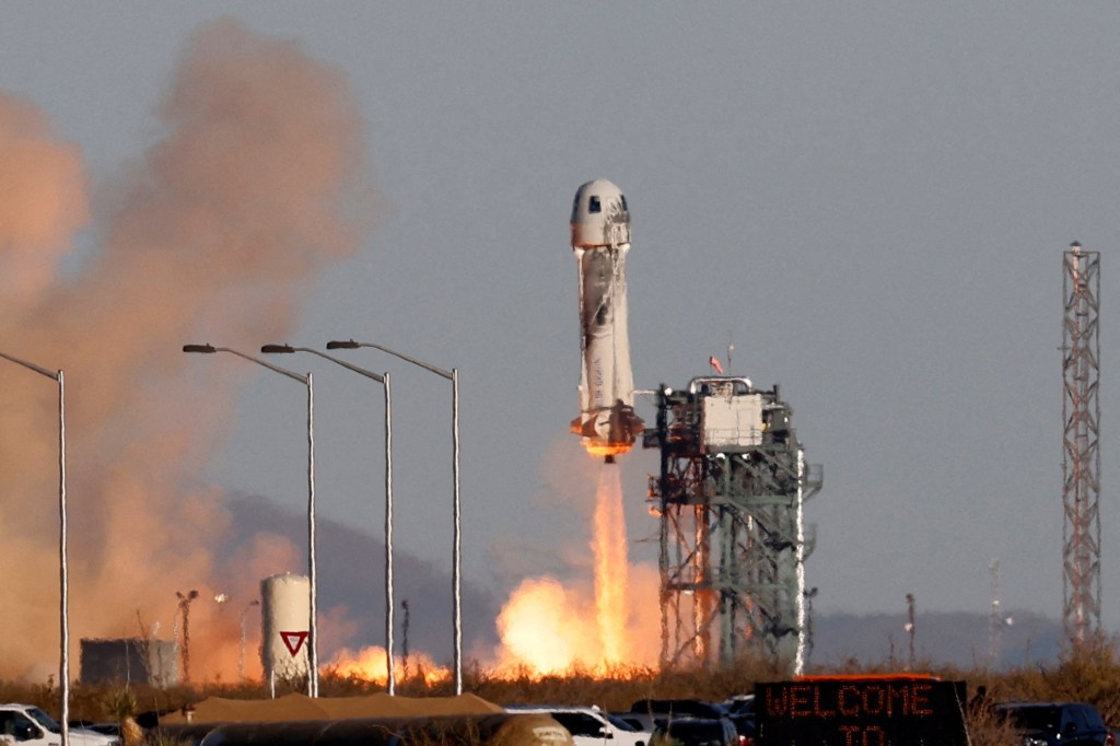 A Blue Origin New Shepard rocket lifts off with a crew of six from Launch Site One in west Texas on December 11, 2021.