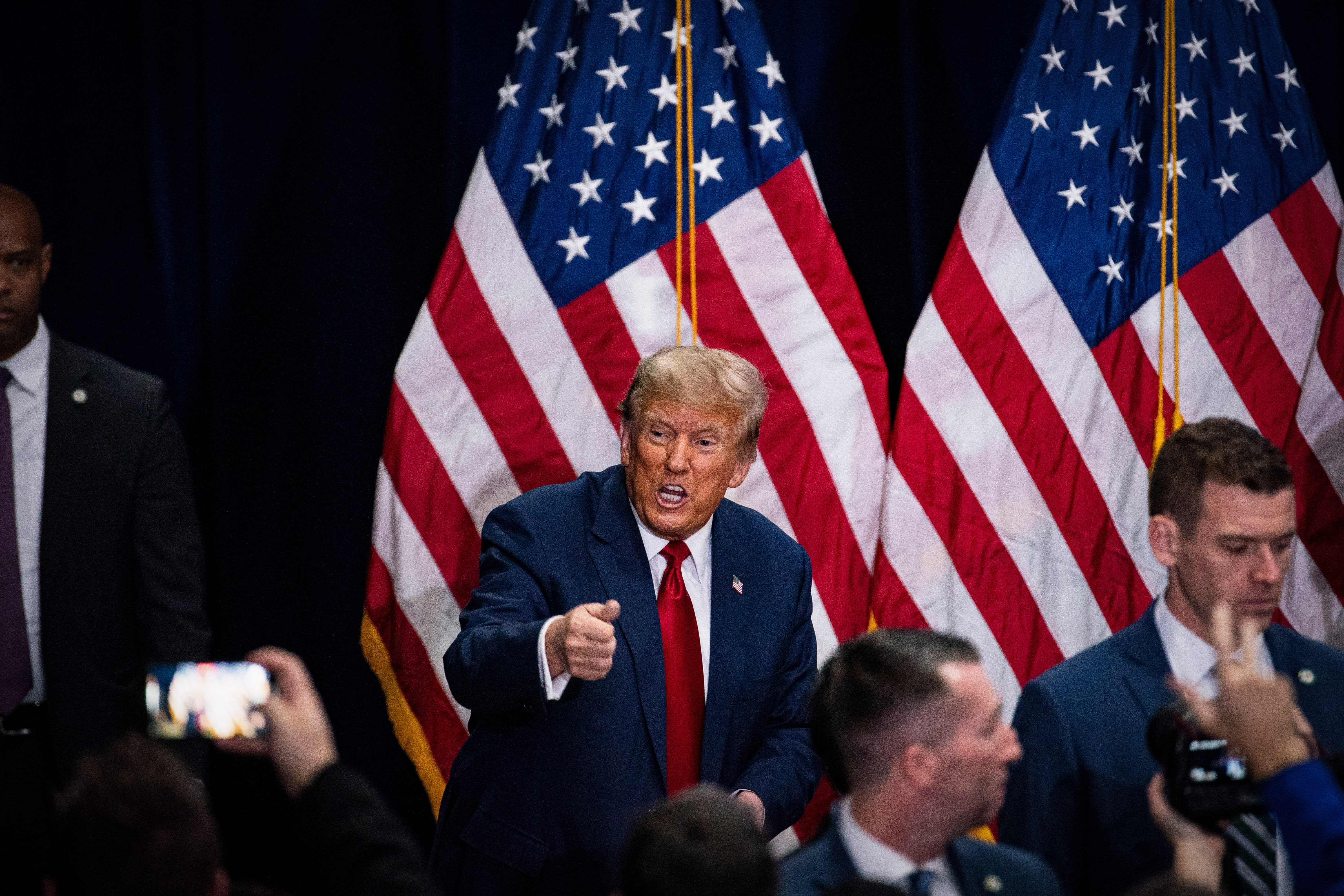 Former US President Donald Trump, center left, departs following a caucus night watch party in Des Moines, Iowa, US, on Monday, Jan. 15, 2024. Trump cruised to victory in the Iowa caucus, warding off a late challenge from rivals Ron DeSantis and Nikki Haley and cementing his status as the clear Republican frontrunner in the race. Photographer: Al Drago/Bloomberg via Getty Images