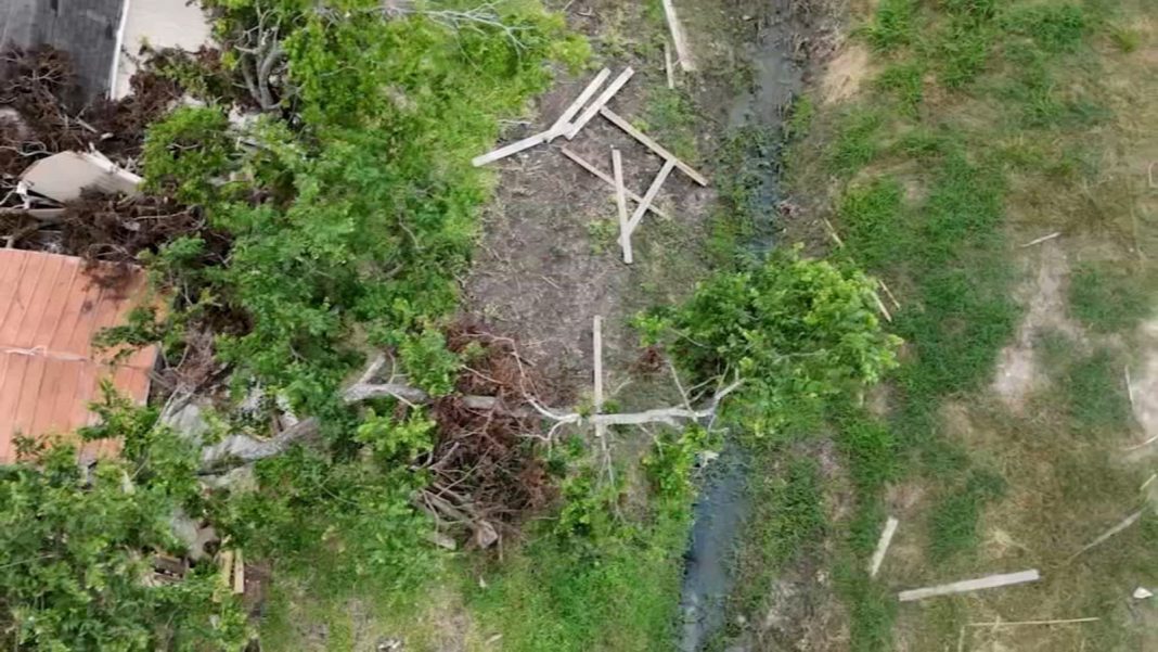 Spring Branch Couple Seeks Help Removing Fence from Drainage Ditch Behind Home